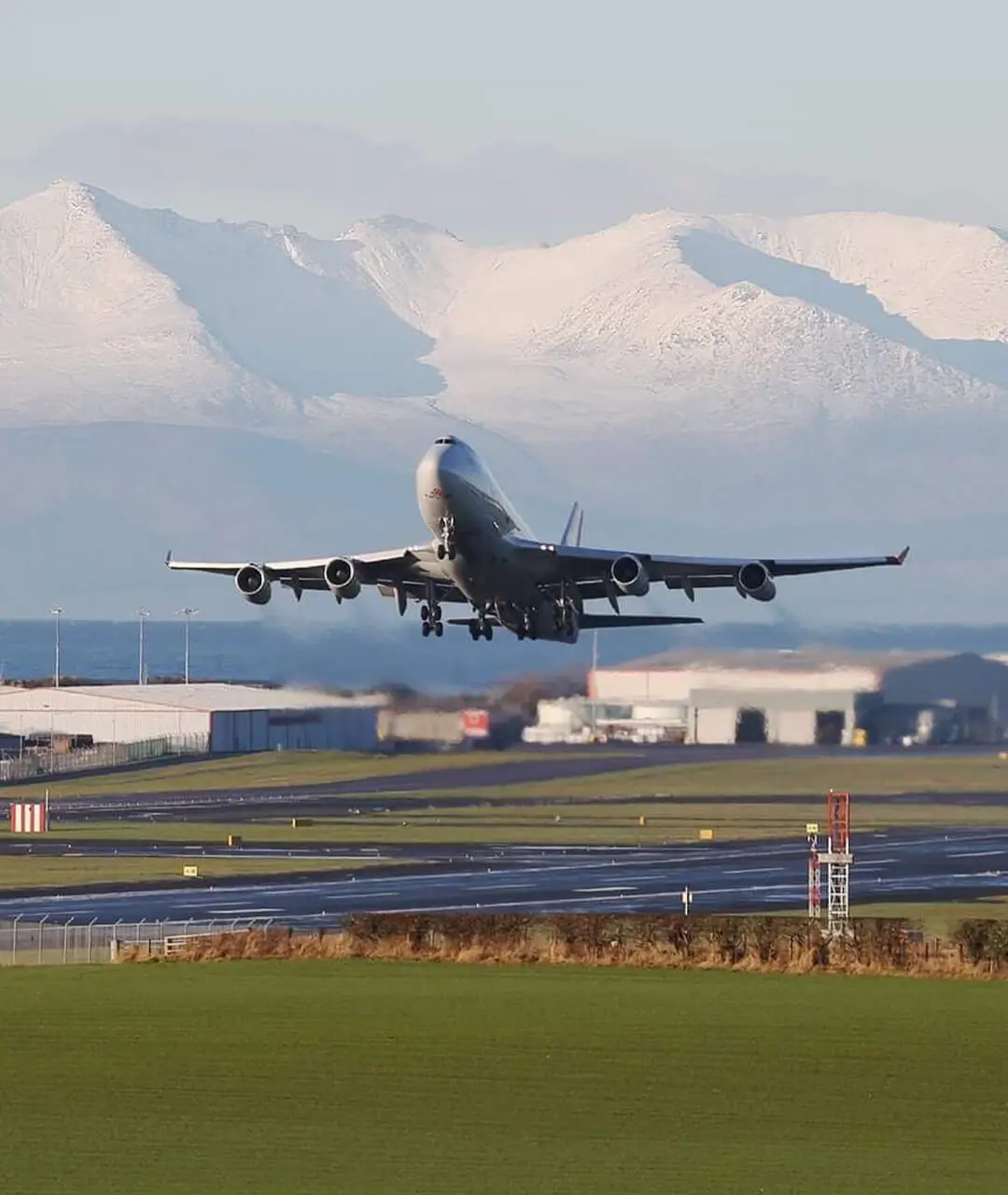 cargolux-aircraft-taking-off-with-snow-covered-arran-in-distance