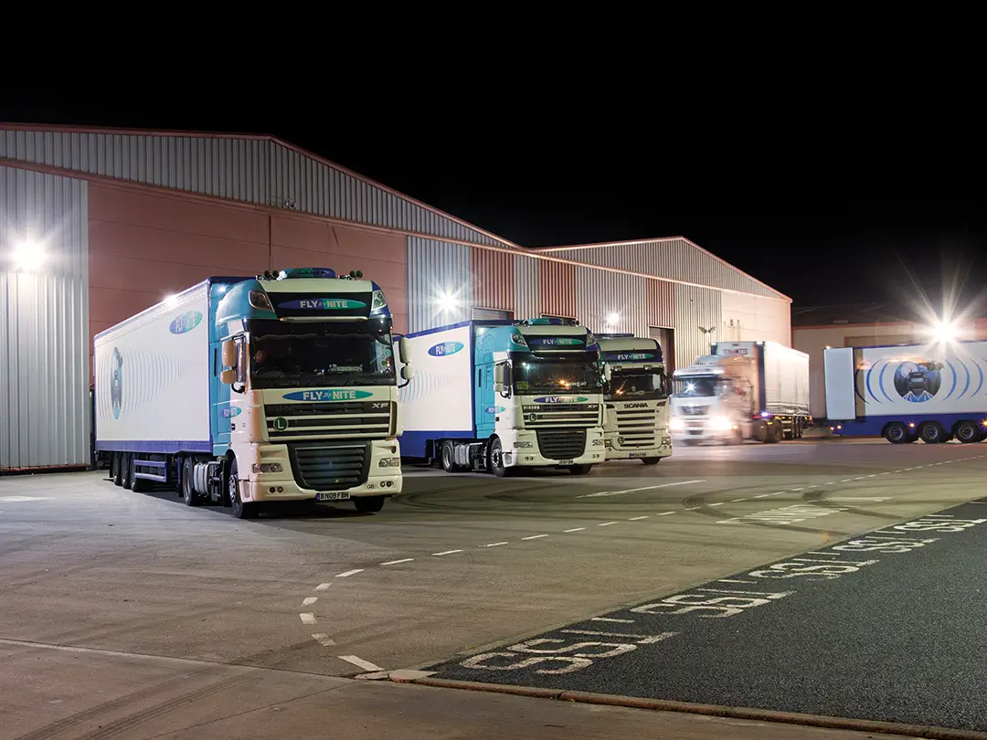 night-shot-of-distibution-vehicles-at-warehouse